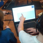 Boy pointing at screen